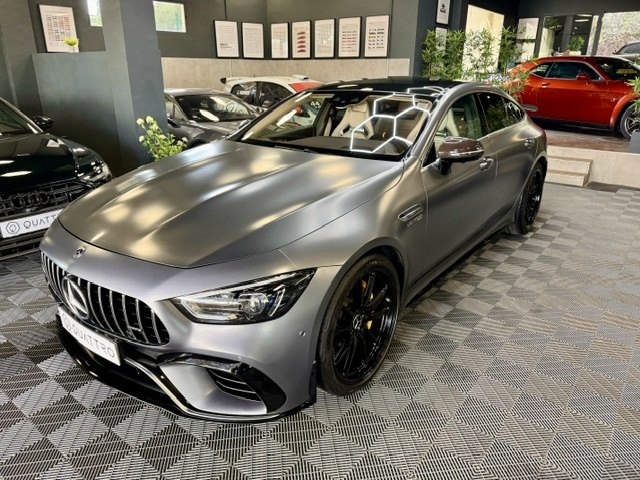 A satin grey Mercedes-AMG GT 63 four-door coupé in the showroom