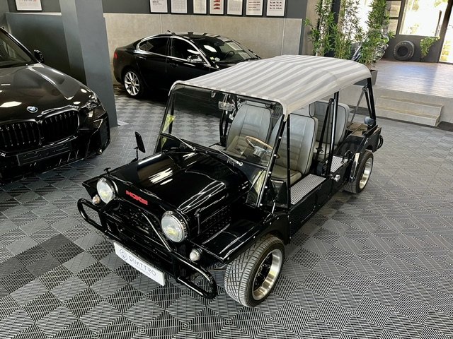 Black Mini Moke with a striped canopy